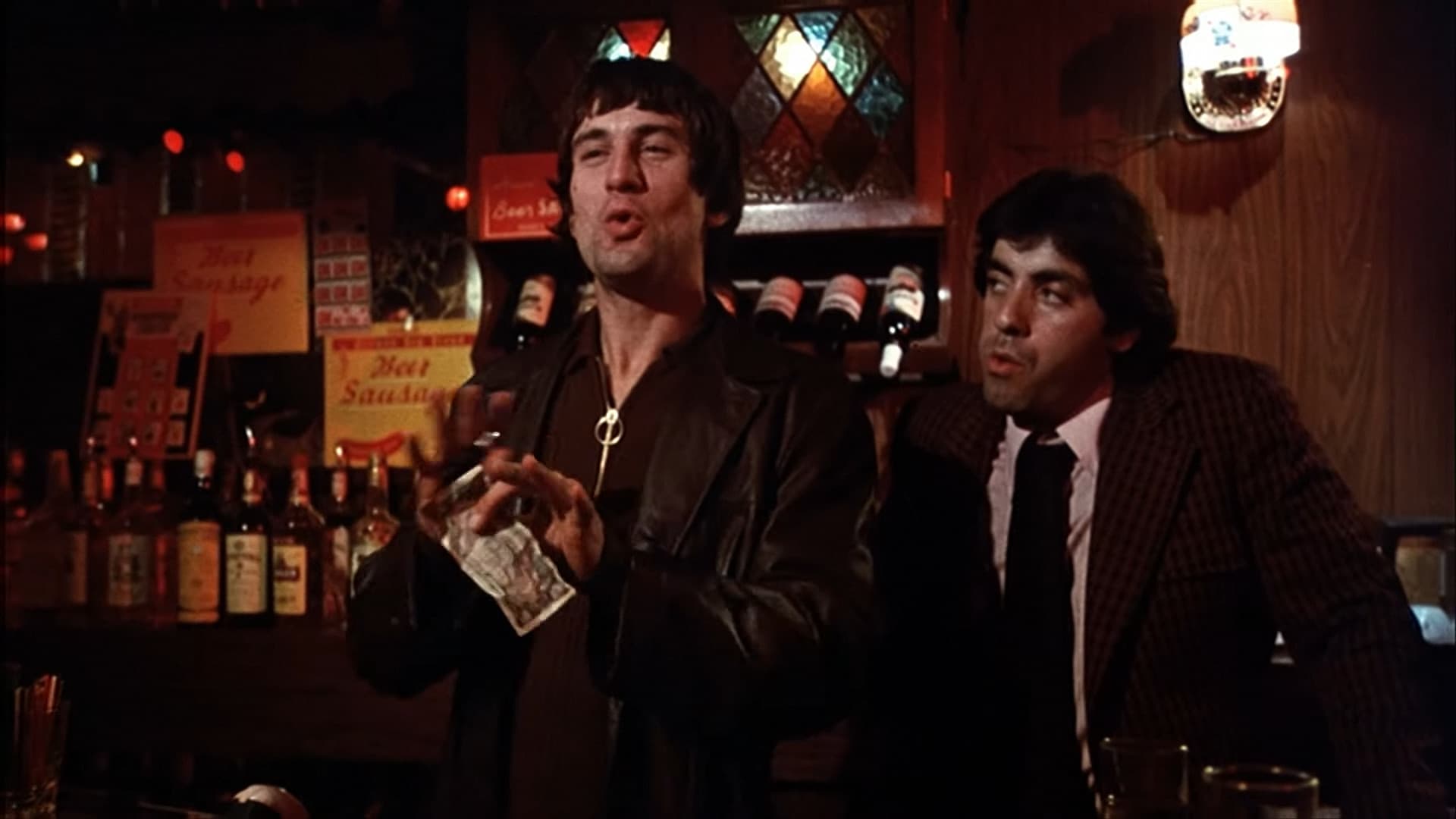 A still from Mean Streets — figures in the red-lit bar of the neighborhood Scorsese grew up in